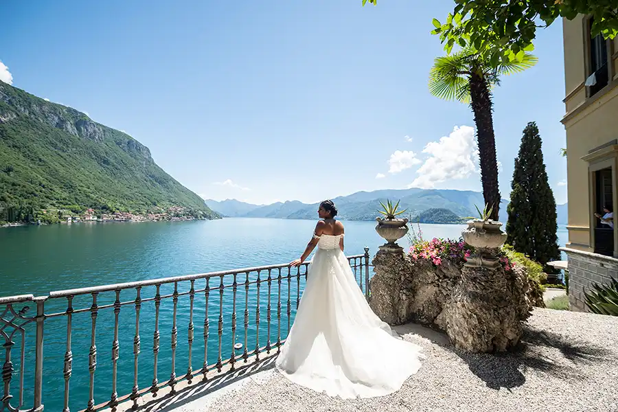 Bride overlooking Lake Como from a panoramic terrace during a luxury wedding in Italy.