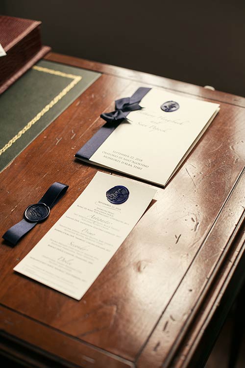 Stationary in precious white paper with a dark blue hand made wax seal and blue ribbon