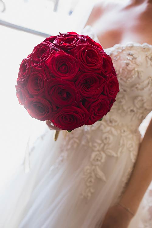 Bridal bouquet was a splendid and perfect sphere of red roses