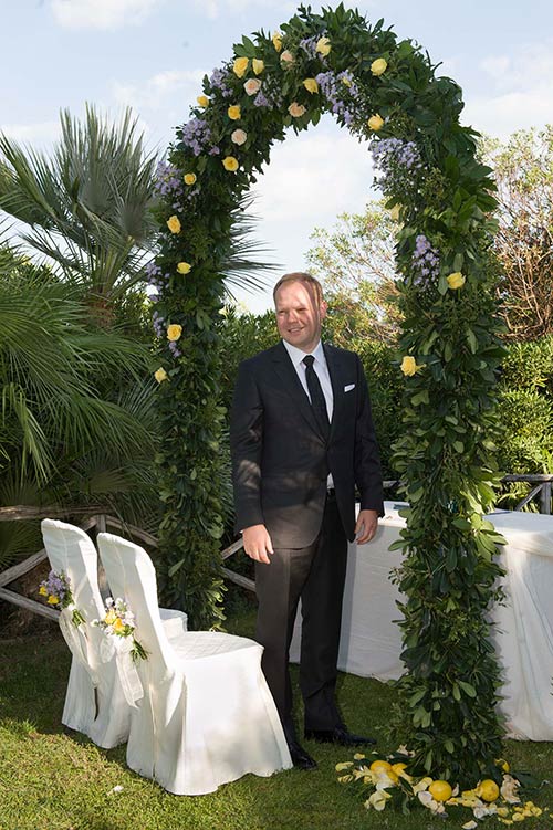Konrad under the ceremony's floral arch