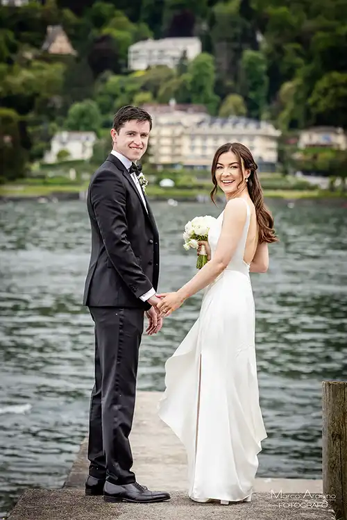 Bride and groom on a lakeside pier during a wedding on Lake Maggiore