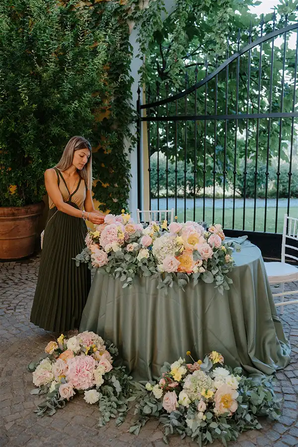 Wedding planner Carola Biasetti styling a floral reception table on the Italian Riviera