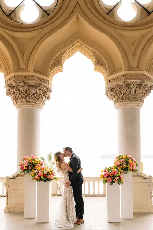 Bride and groom under the loggia at Isola del Garda during a wedding on Lake Garda