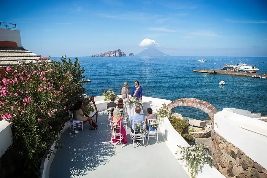 Intimate seaside wedding ceremony in Sicily with island and volcano views