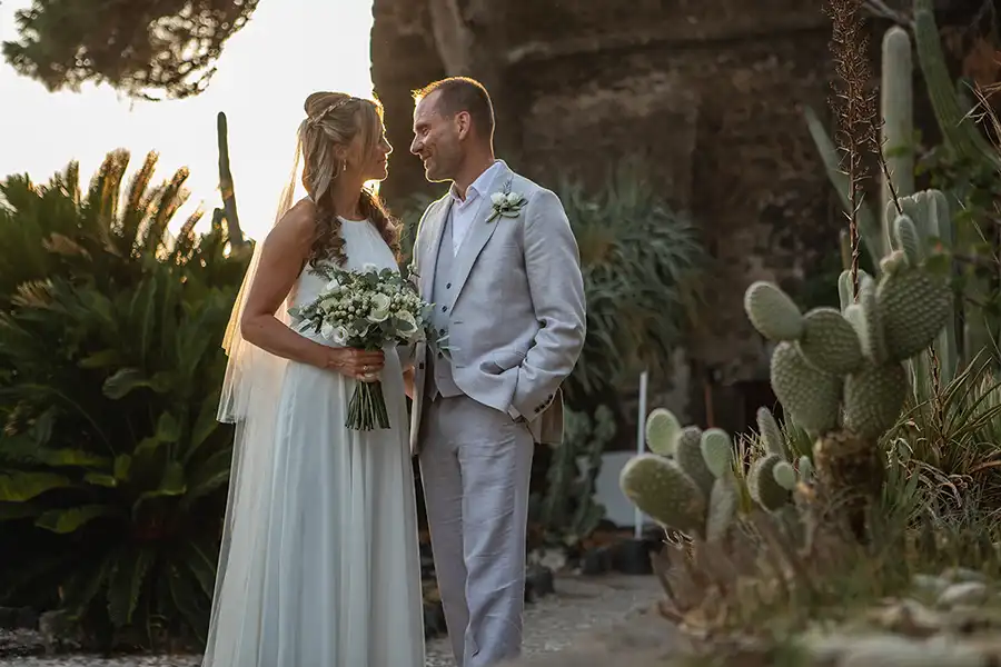 Bride and groom portrait in a Sicilian garden with cactus plants at sunset