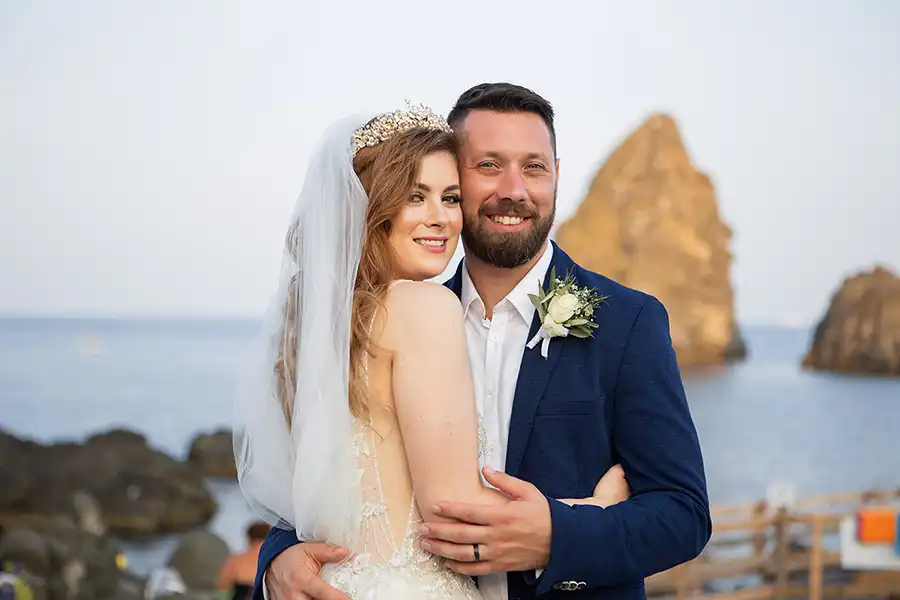 Bride and groom portrait with sea stacks in the background during a wedding in Sicily