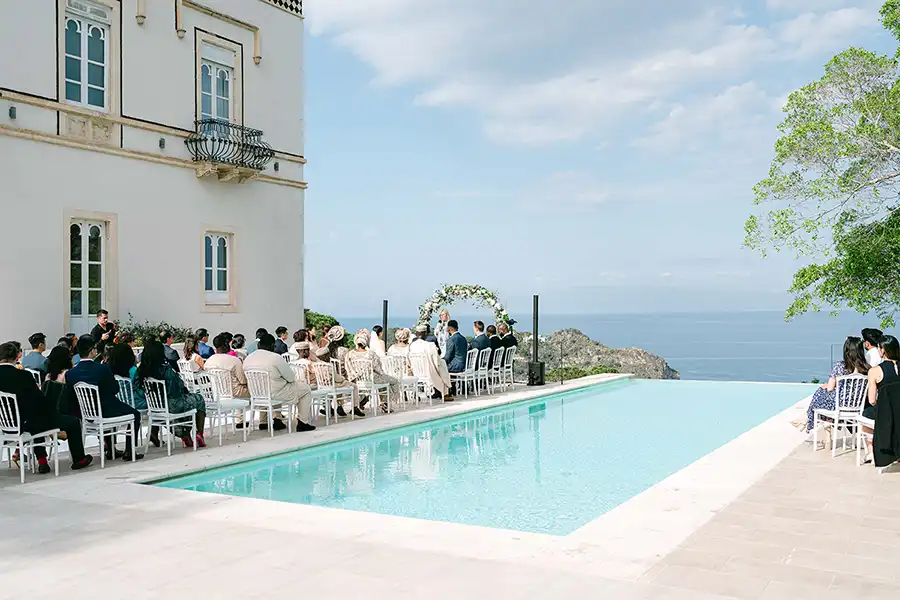 Wedding ceremony by the pool with sea view at a villa in Sicily