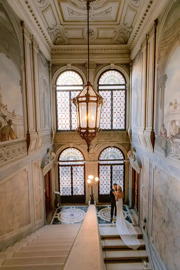 istoriate Bride and groom in the grand staircase hall of a Venetian palace during a wedding in Venice